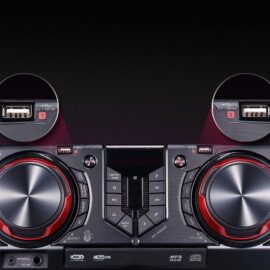 Top control panel of the LG CJ44 showing two large dials, a red LED display, playback keys, USB REC, Auto DJ, Key Changer, and close-ups of the two front USB ports