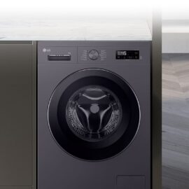 LG 9kg front load washing machine installed beside a kitchen counter, showing the glass door, control dial and LED display