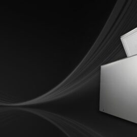 LG chest freezer in silver with the lid raised, showing the white lid liner and a control with indicator light on the lower front panel