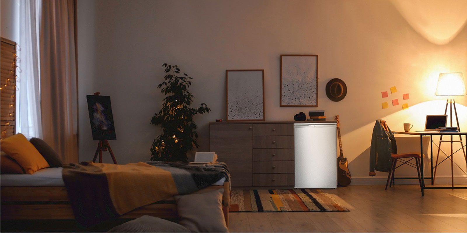 LG GL-131SQQP 92L Direct cooling, low voltage stabilizer(110v - 290v), Freezer Compartment, Two Wire Shelves, White 3 The white LG refrigerator placed next to a chest of drawers in a bedroom at night