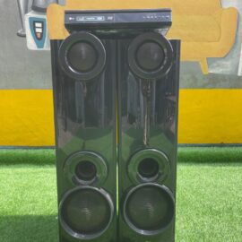 LG LHD667 DVD deck on top of two black gloss tower speakers, straight on view