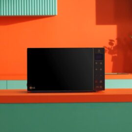 LG NeoChef microwave on a kitchen counter, flat glass front with touch keys and a red digital display on the right